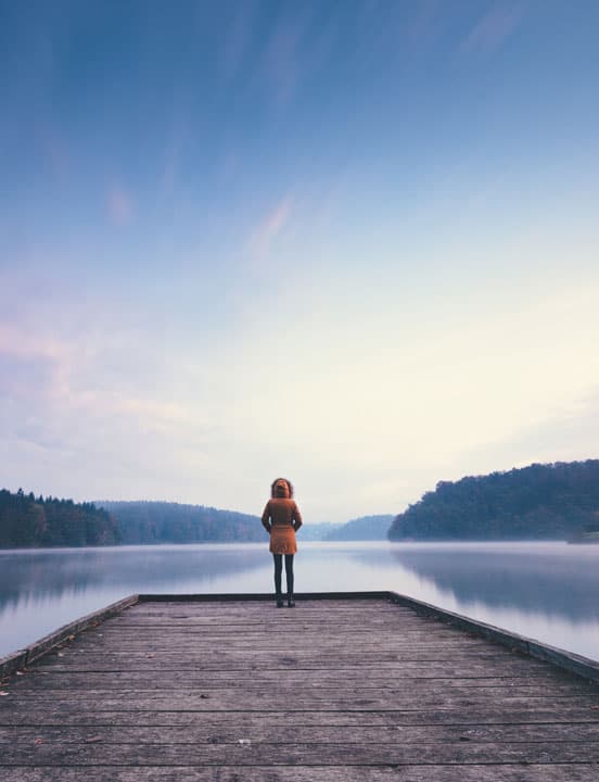 woman at end of wooden pier