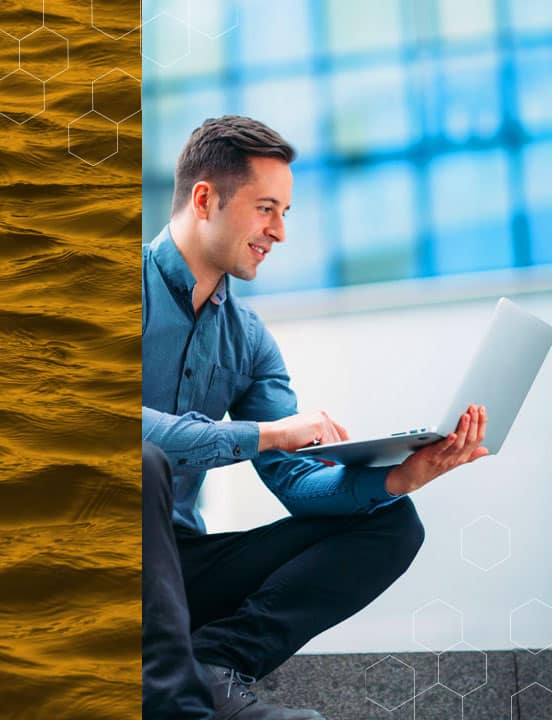 man-working-on-computer-outside-office-building