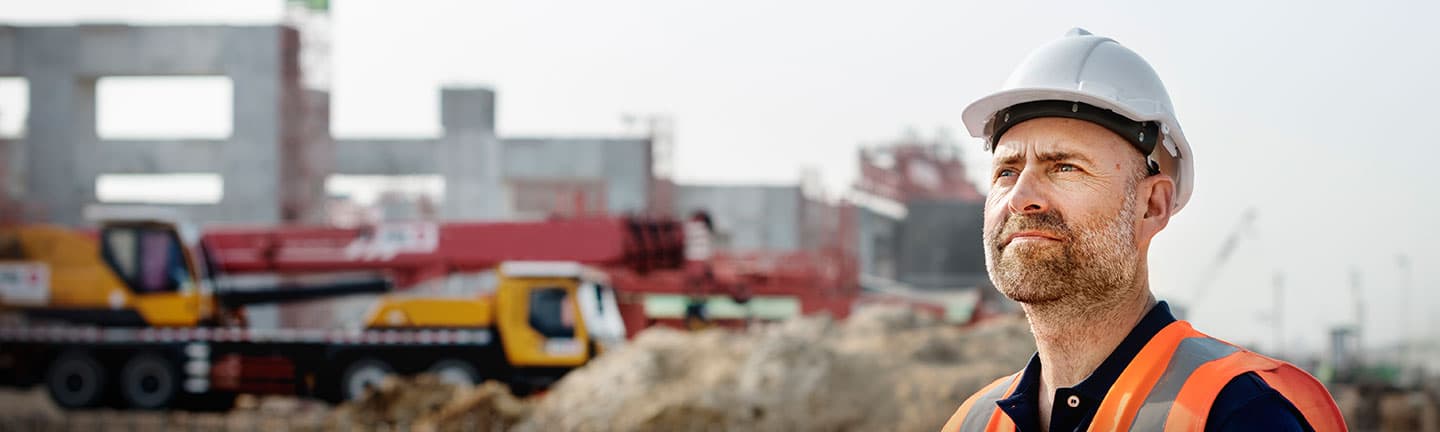 construction worker with hard hat looking in distance