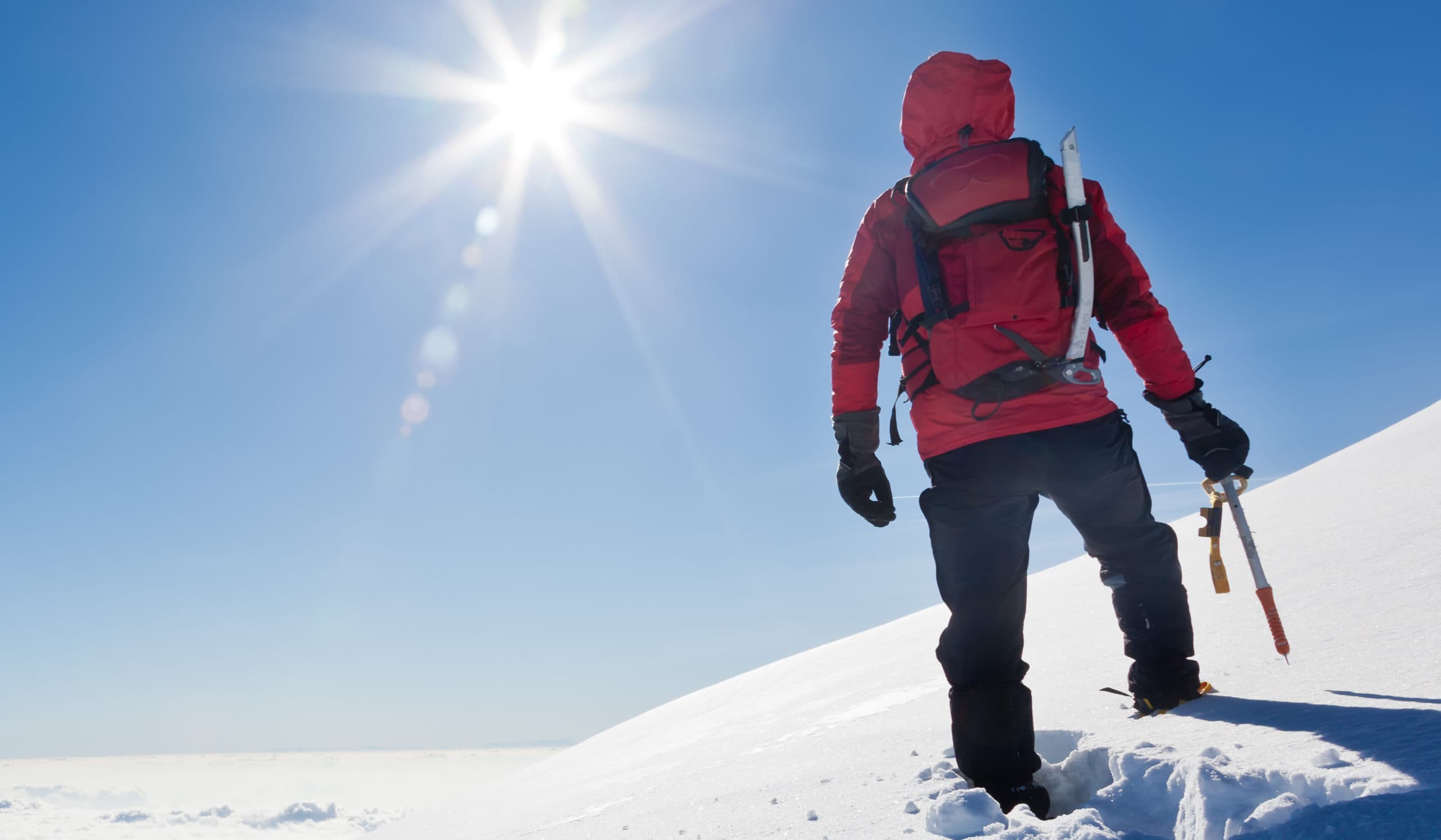 person hiking in snow covered landscape