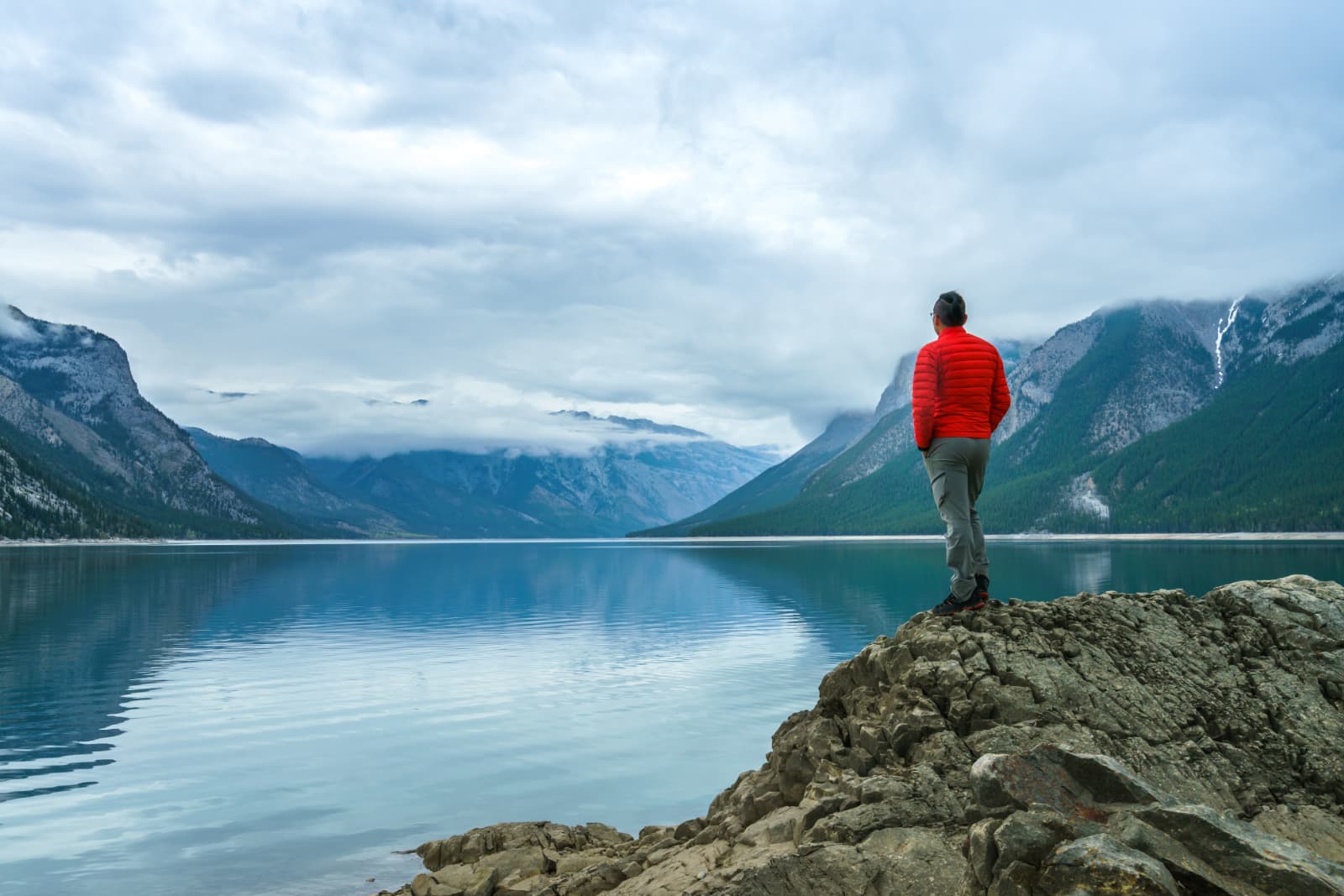 Hiking man arms open to nature view