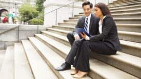 couple sitting on steps of government building