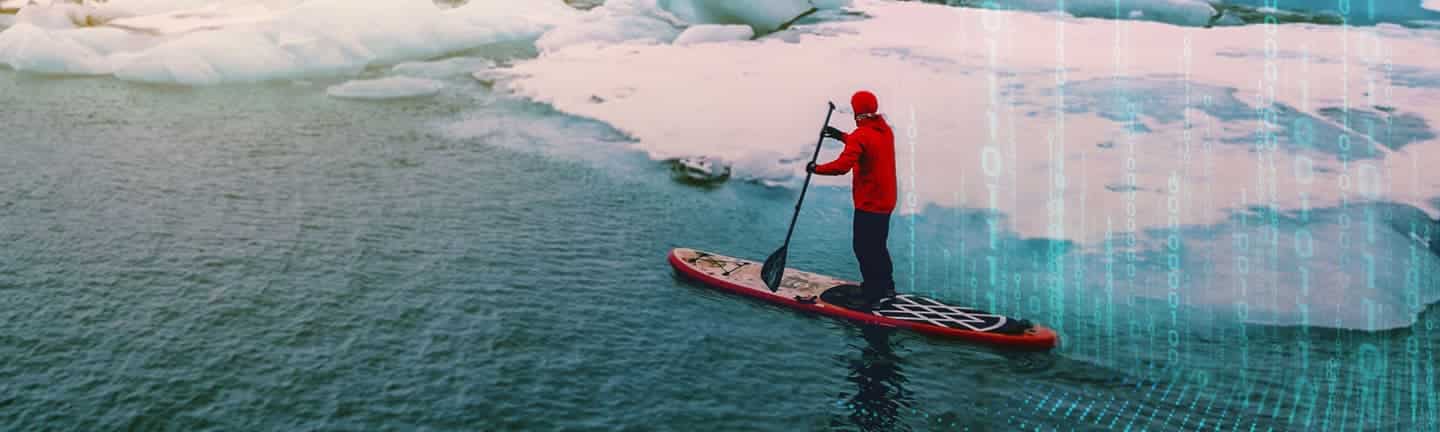 person paddle boarding on ice lake