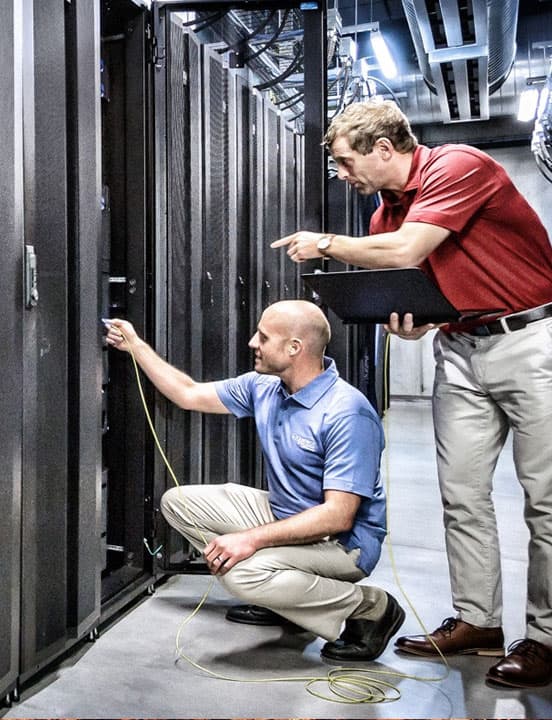 two it managers checking network at data center