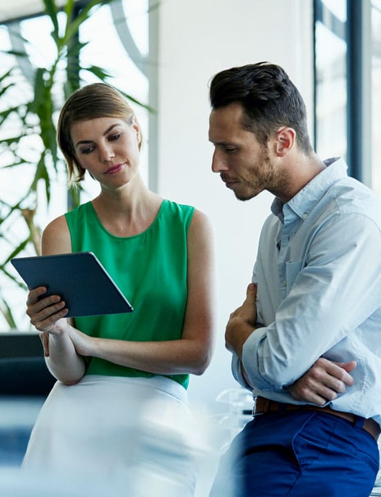 business man and woman looking at tablet