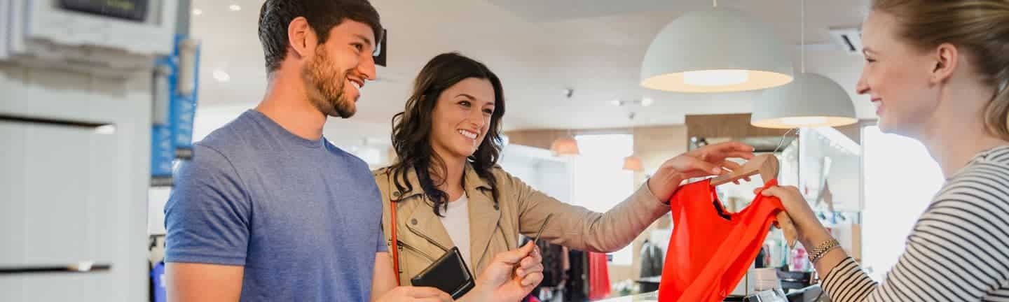 women at retail store making a purchase