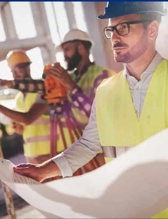 construction worker looking at architecture design