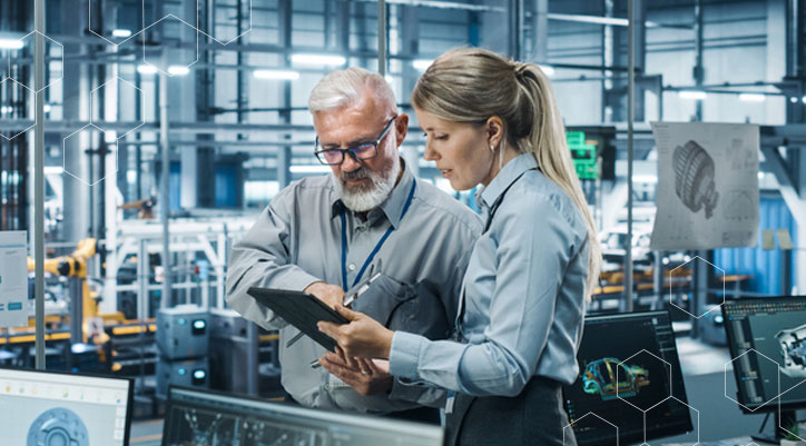 man-woman-car-factory-looking-at-computer-data