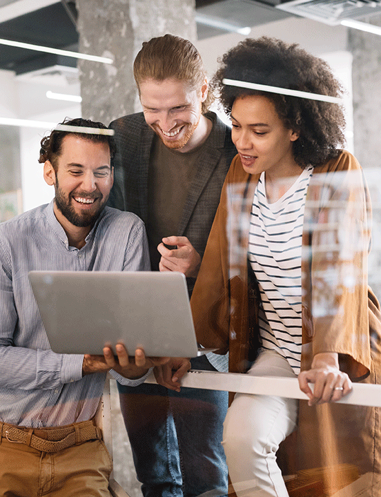 employees gathered around computer