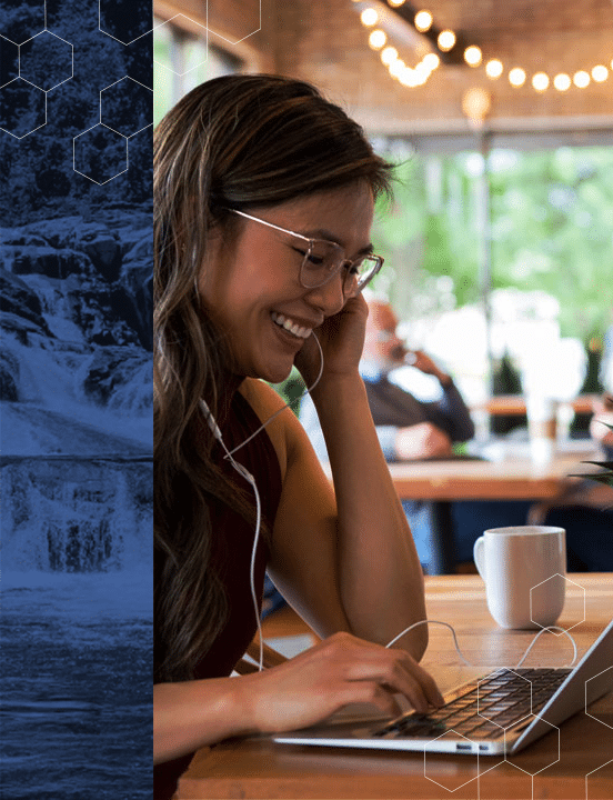 woman sitting in cafe talking with coworkers through microsoft teams