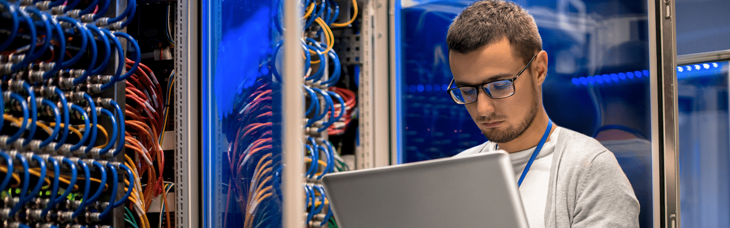 man-in-datacenter-looking-at-computer-storage